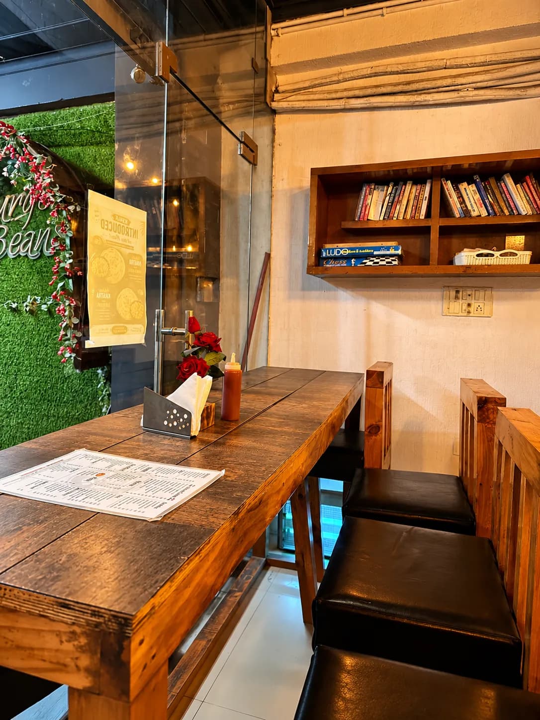Window seats with a shelf of books, Ludo and chess